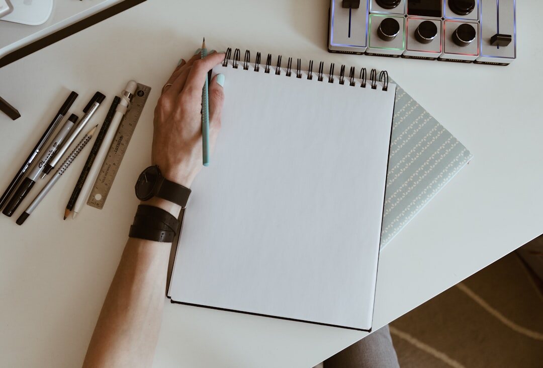 person writing notes in notebook